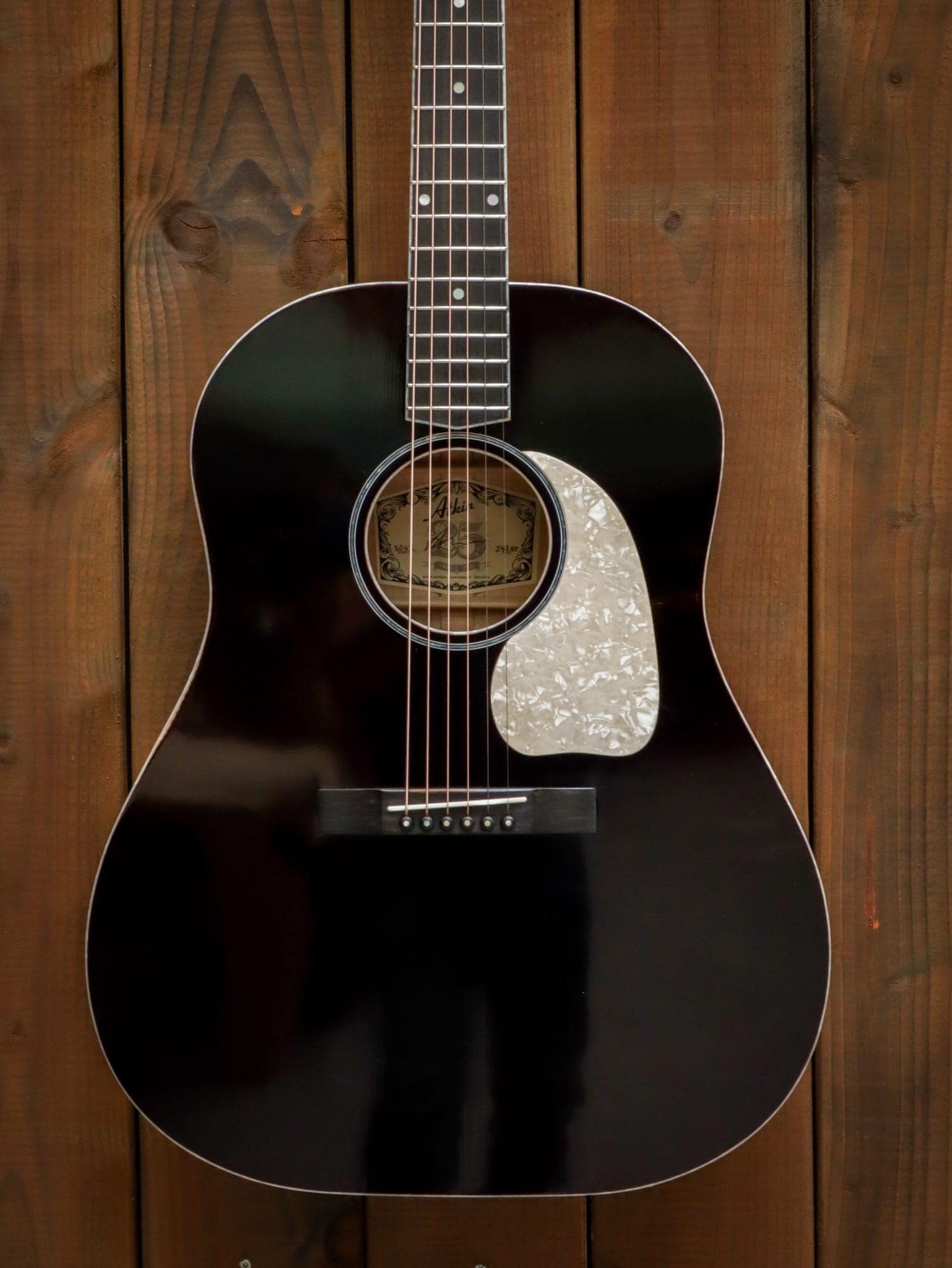 black acoustic guitar white pickguard